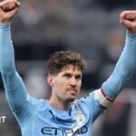 Manchester City defender John Stones celebrates with arms aloft after his side's FA Cup win over Newcastle United