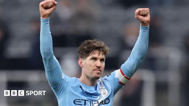 Manchester City defender John Stones celebrates with arms aloft after his side's FA Cup win over Newcastle United