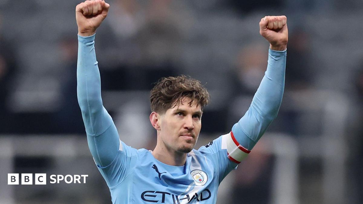 Manchester City defender John Stones celebrates with arms aloft after his side's FA Cup win over Newcastle United