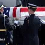 US soldiers carry a casket during a dignified transfer ceremony in Delaware in July