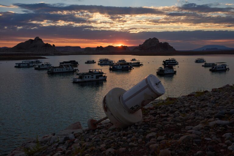 A formerly floating buoy now sits high and dry above Lake Powell
