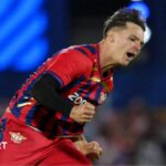 Sonny Baker of Manchester Super Giants, in the team's red and blue kit, celebrates a wicket