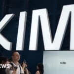 Visitors at a trade show in Shanghai visit a booth with the Kimi sign displayed in large block letters