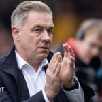 Scott Lindsey applauds the Crawley Town fans after a League Two match