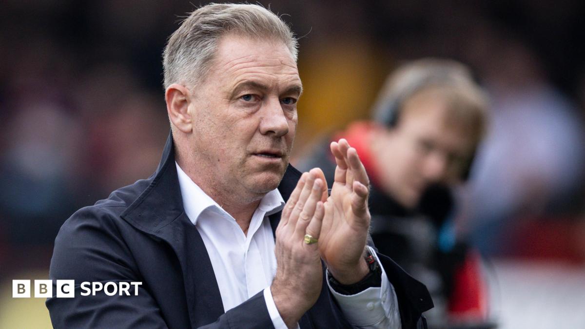 Scott Lindsey applauds the Crawley Town fans after a League Two match