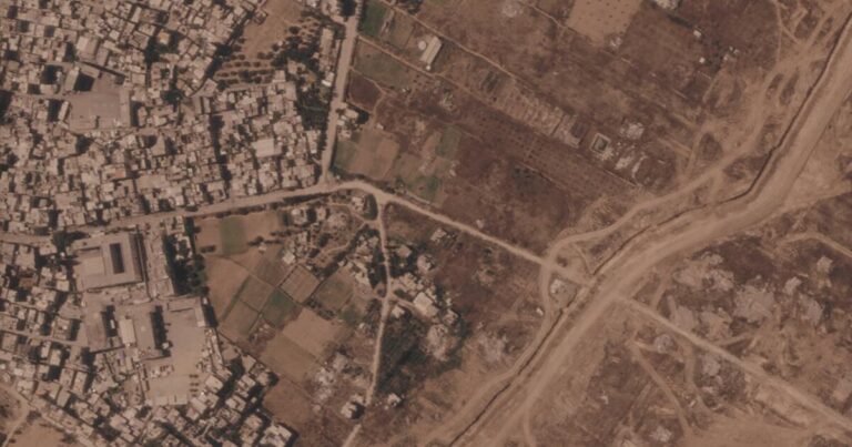 This satellite image from Planet Labs PBC shows a section of an earthen barrier being built by the Israeli military, right