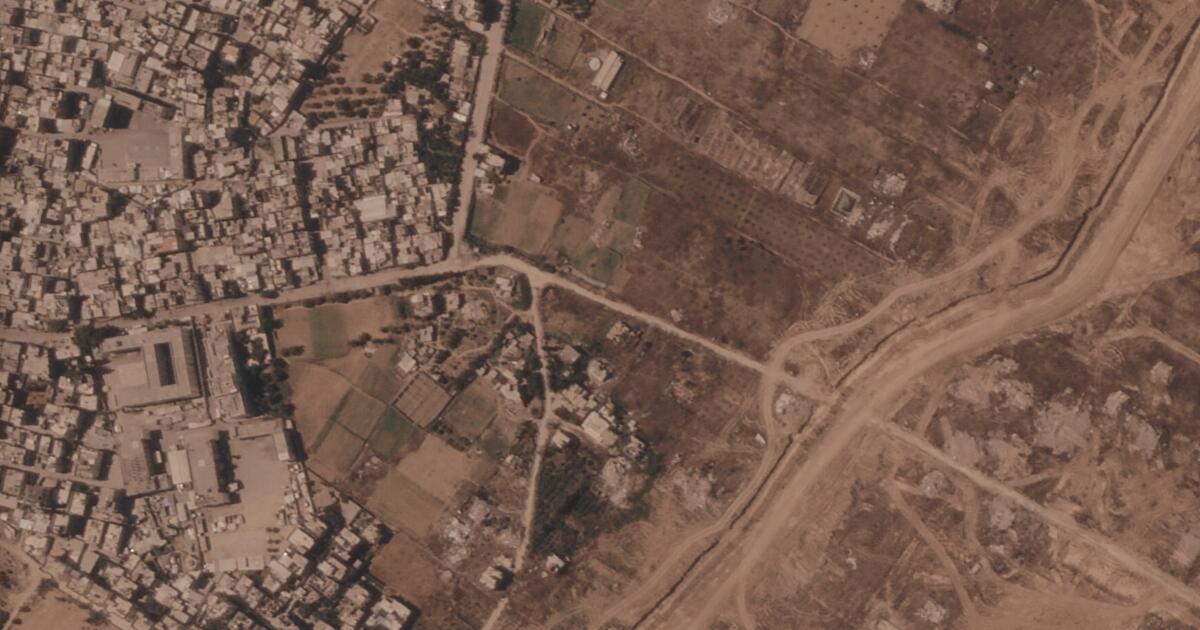 This satellite image from Planet Labs PBC shows a section of an earthen barrier being built by the Israeli military, right