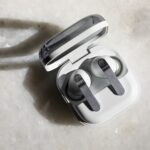 The Samsung Galaxy Buds 4 Pro in their open charging case on a white tabletop