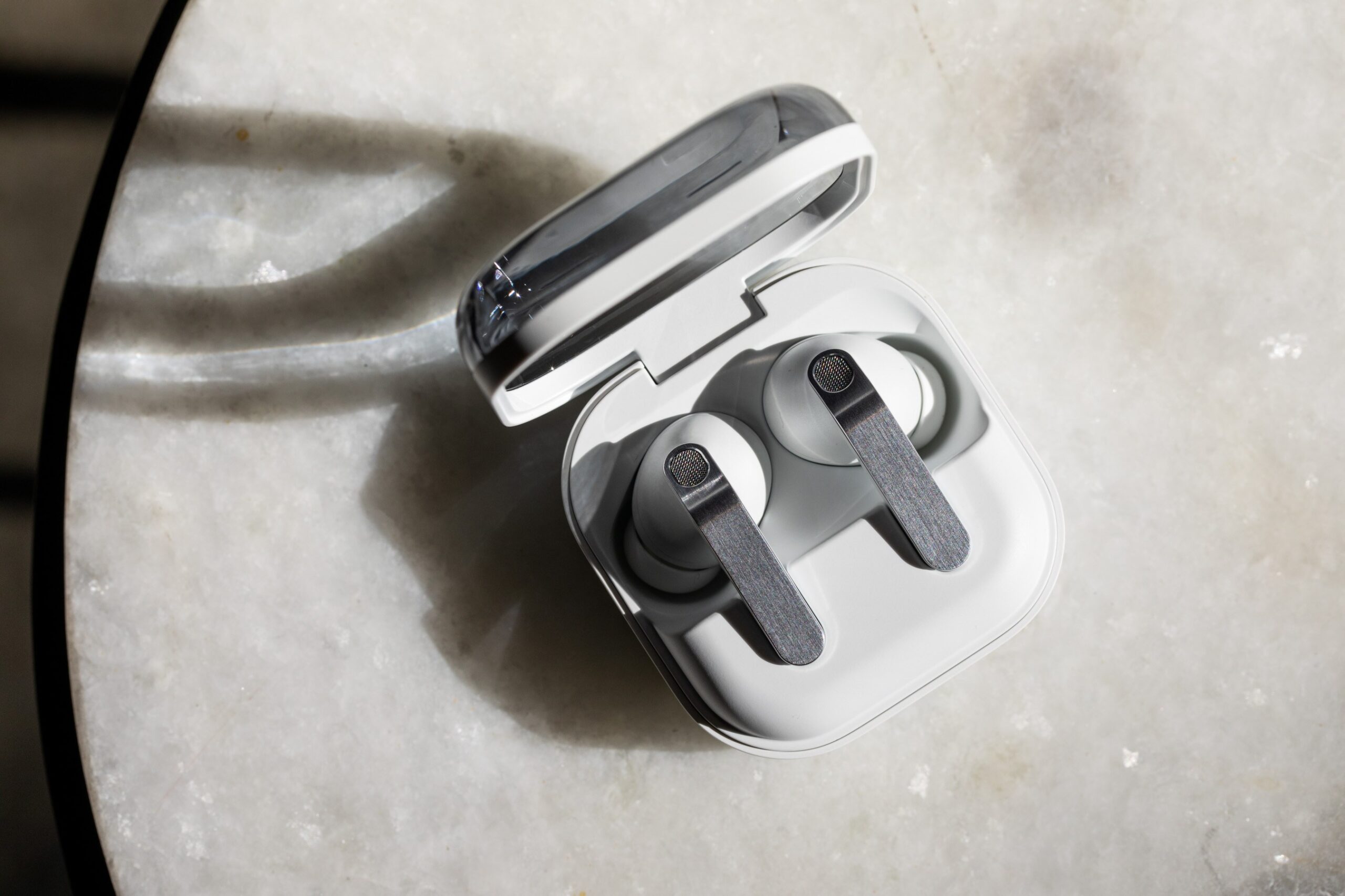 The Samsung Galaxy Buds 4 Pro in their open charging case on a white tabletop
