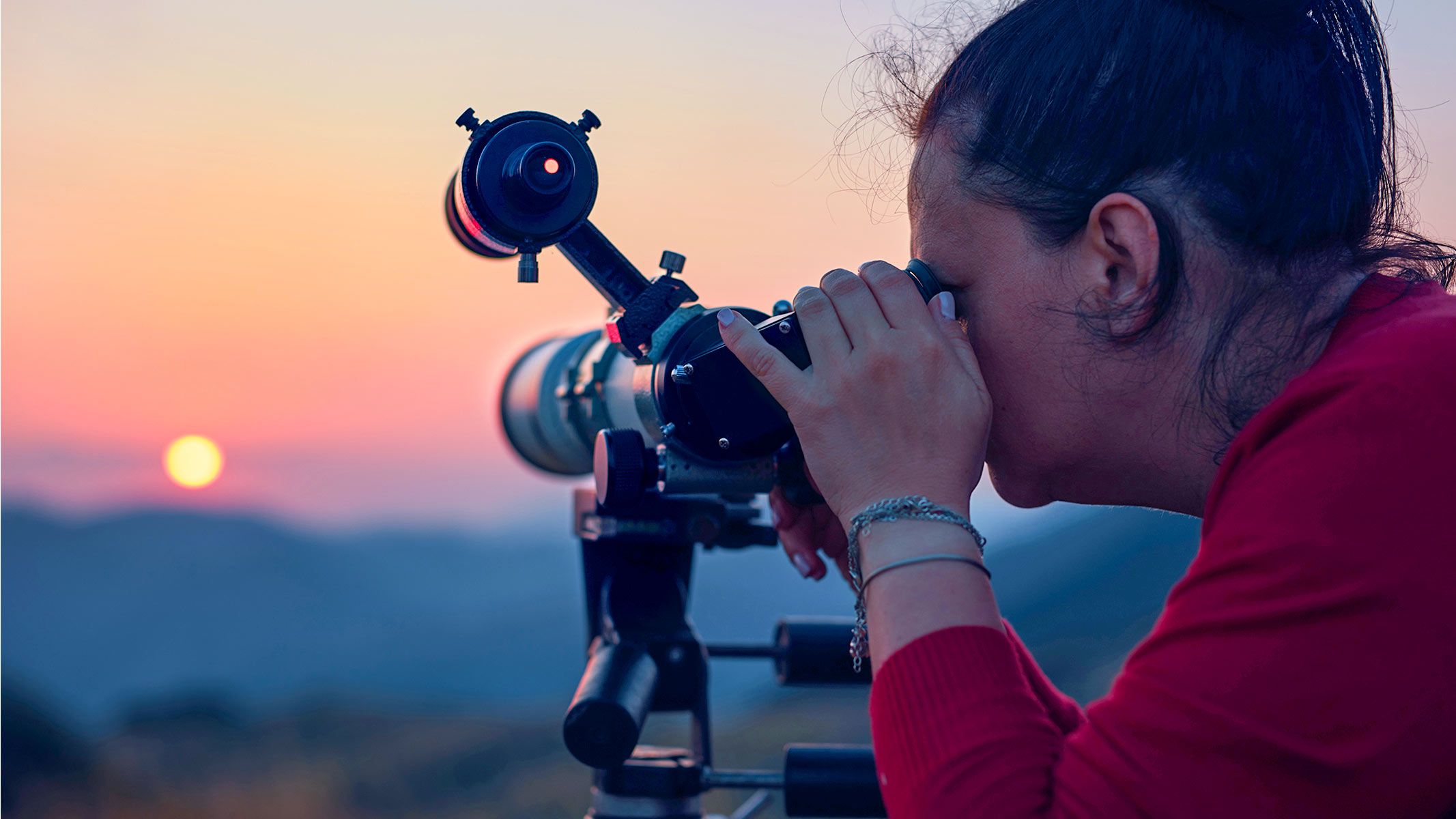 Woman using a solar telescope to look at the sun safely