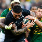 Codie Taylor of the All Blacks tackled by Handre Pollard and Siya Kolisi (captain) of the Springboks during the Castle Lager