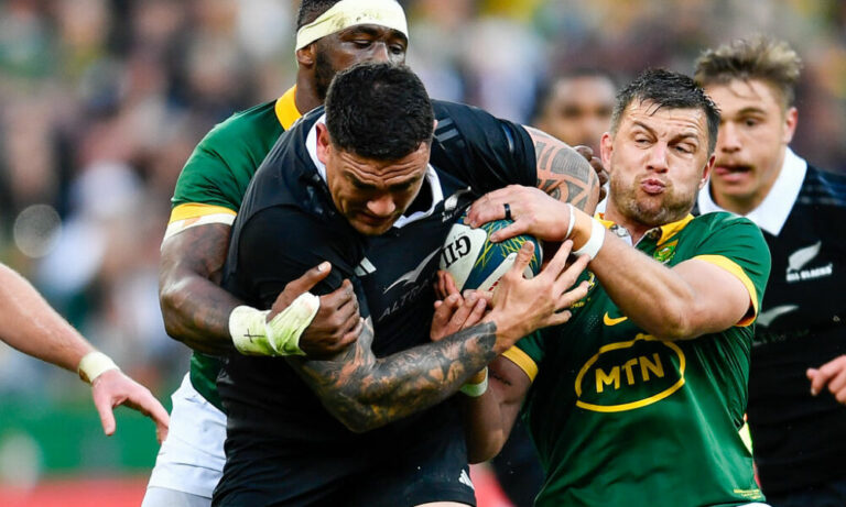 Codie Taylor of the All Blacks tackled by Handre Pollard and Siya Kolisi (captain) of the Springboks during the Castle Lager