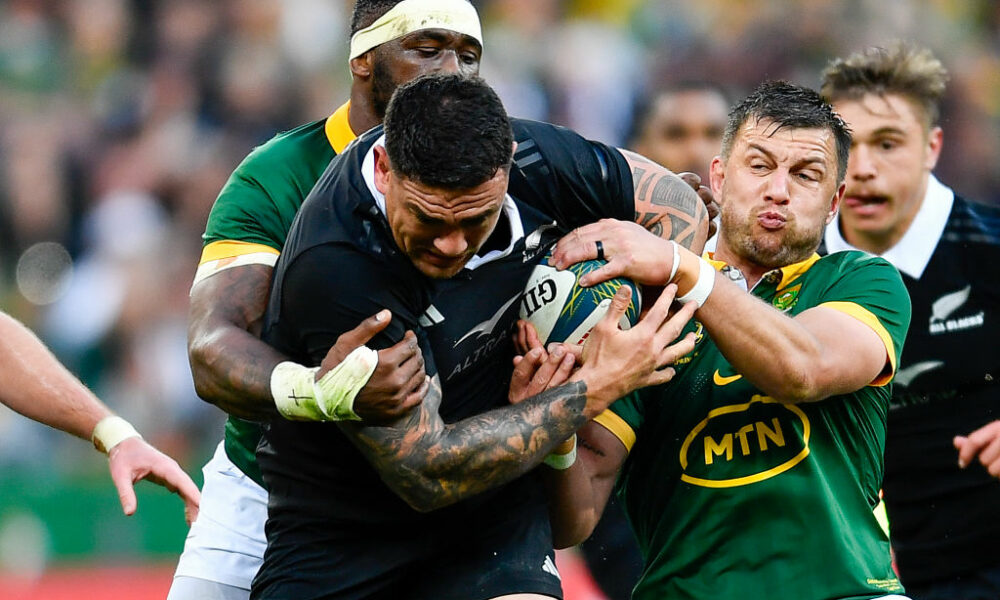 Codie Taylor of the All Blacks tackled by Handre Pollard and Siya Kolisi (captain) of the Springboks during the Castle Lager