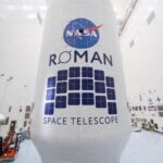 Close-up view of the Roman Space Telescope’s payload, wrapped in white covering with the NASA logo and Roman Space Telescope