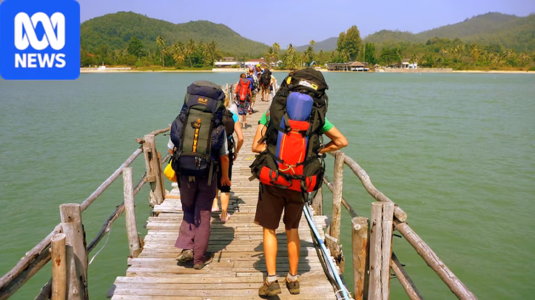 Backpackers walking over a bridge