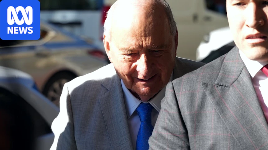 Man in tan suit, white shirt and blue tie in the street