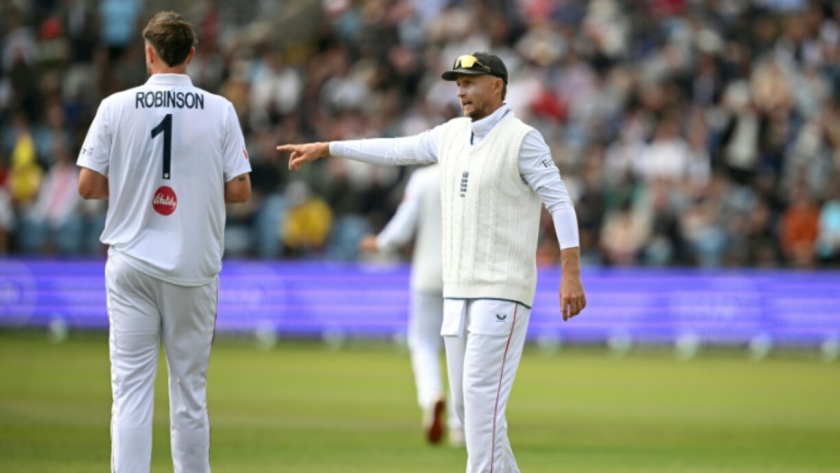 England captain Joe Root (R) speaks with Ollie Robinson during an innings and 103-run win over Pakistan in the first Test at