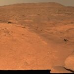 A view of a region of Mars with some rocks strewn about
