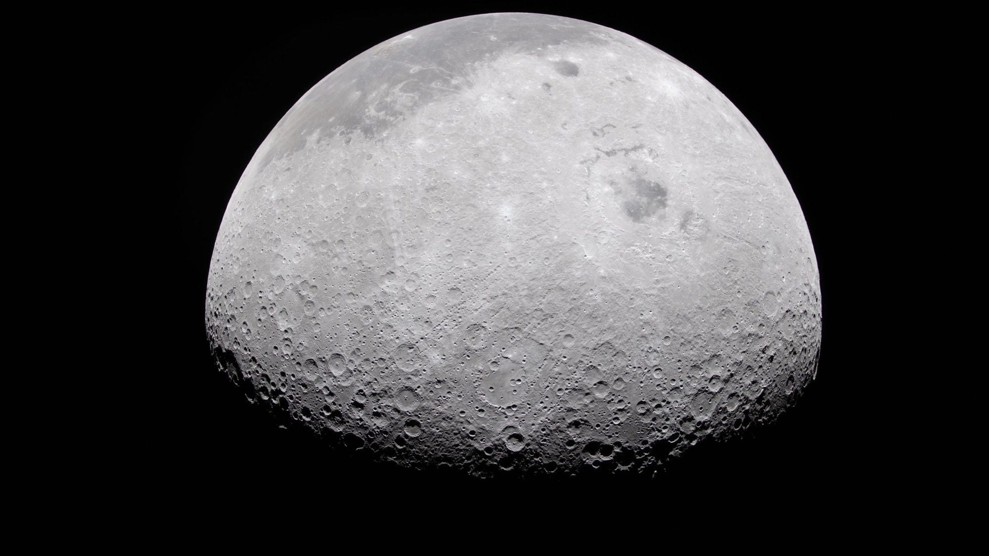 a grey, crater-marked orb on a black background