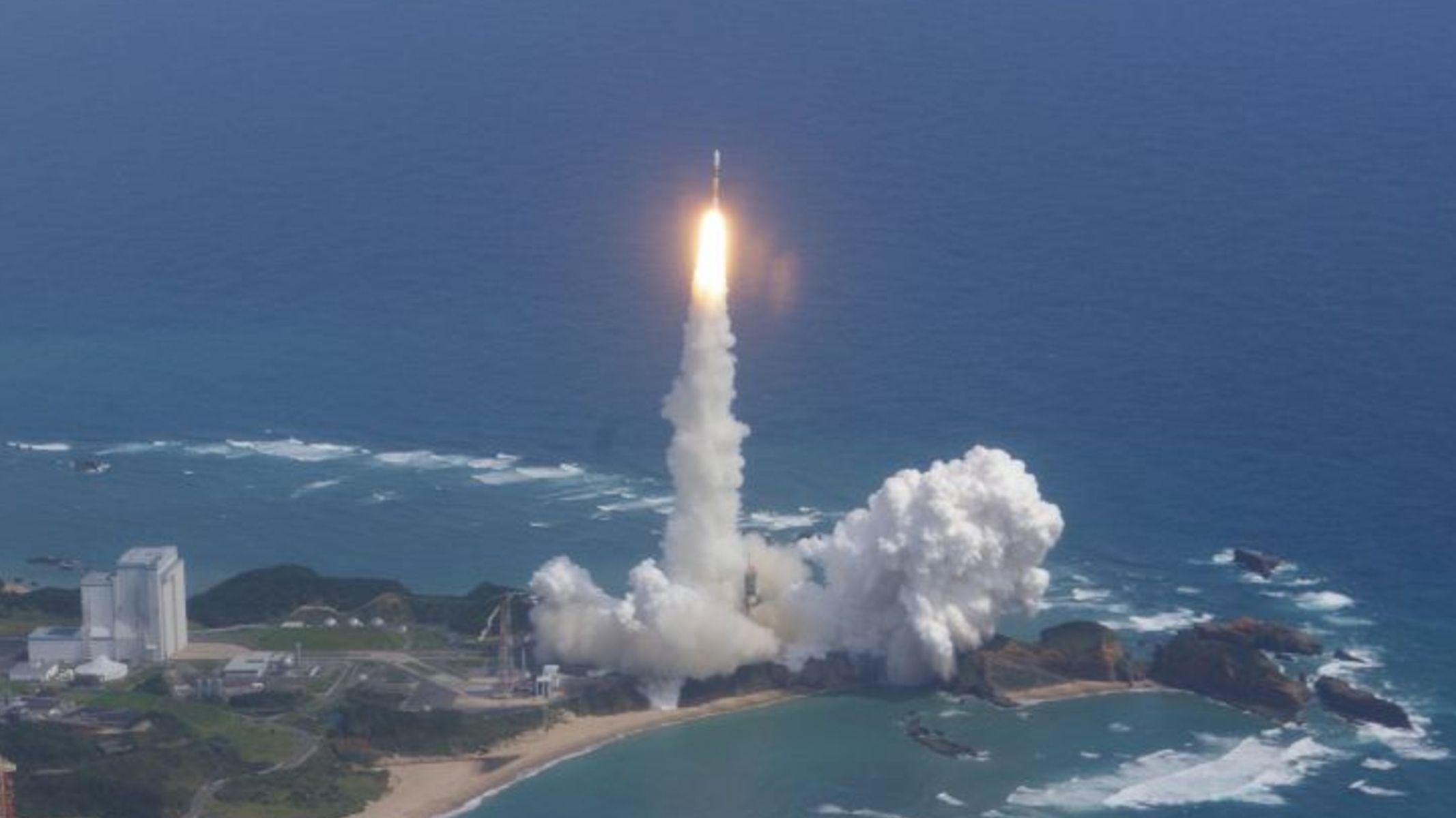 A white and yellow Japanese rocket launches the Kaguya spacecraft to the moon on Sept. 13, 2007