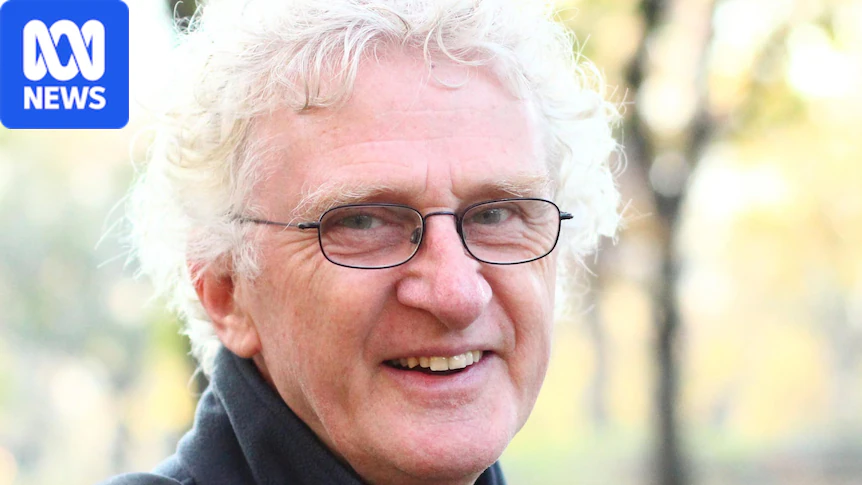 Terry Denton smiles at the camera wearing glasses and smiling
