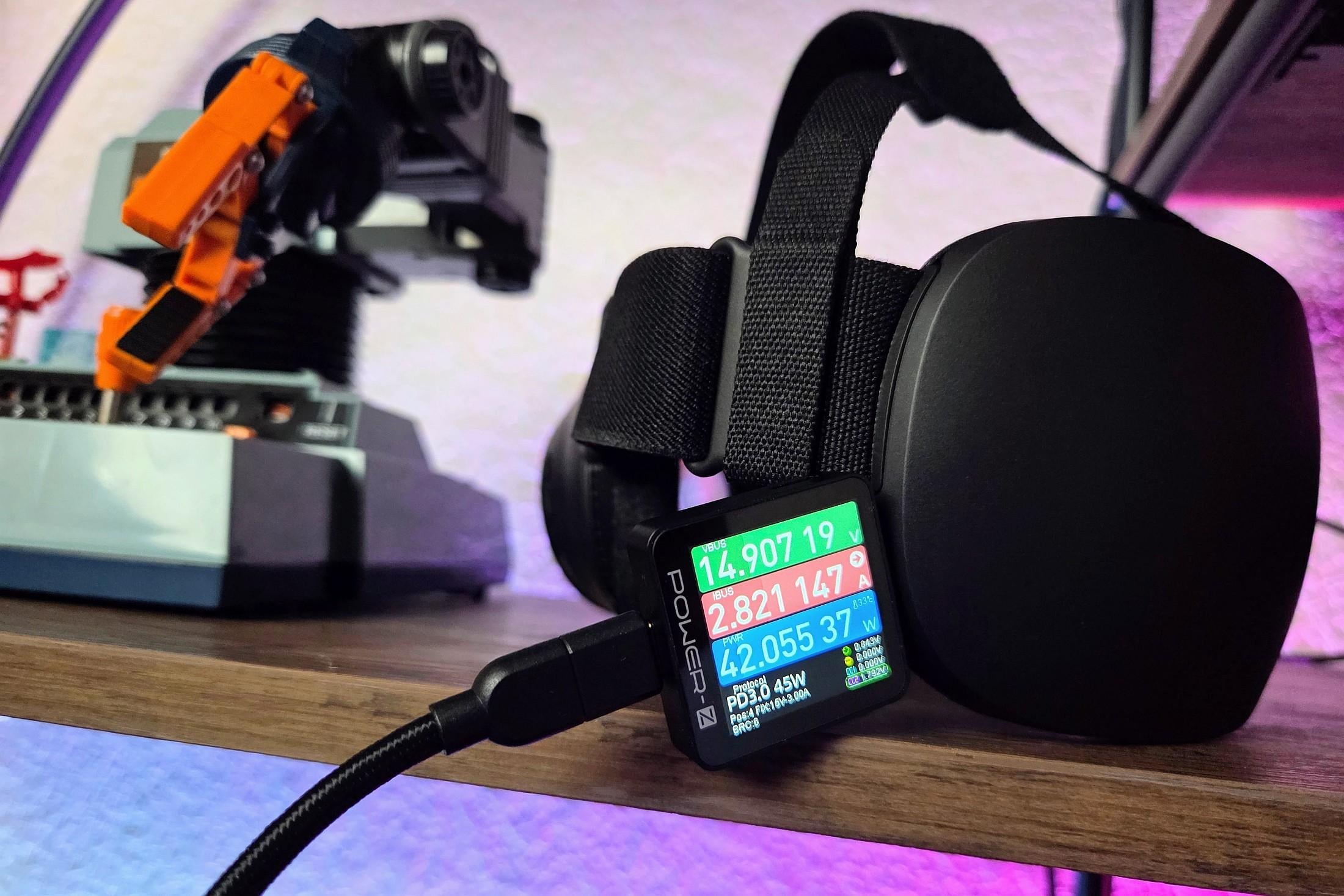 a Steam Frame on a shelf with a USB-C power monitor plugged in displaying 42 watts