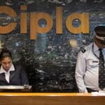 Employees and security staff work at the reception area of Cipla at its headquarters in Mumbai, India June 17, 2015