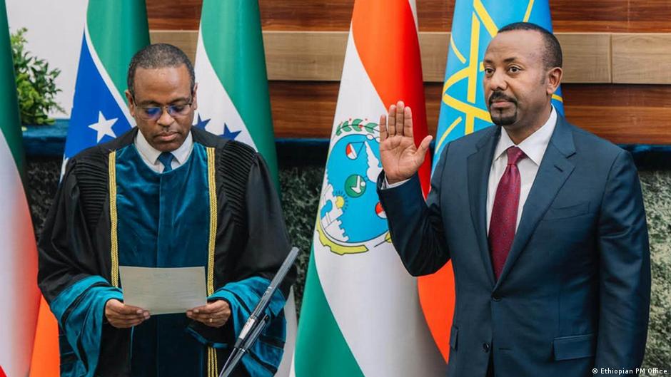 Ethiopia's Prime Minister Abiy Ahmed raises his right hand during his inauguration ceremony