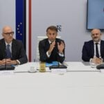 French President Emmanuel Macron (C) speaks next to French Presidential advisor Emmanuel Bonne (L), France