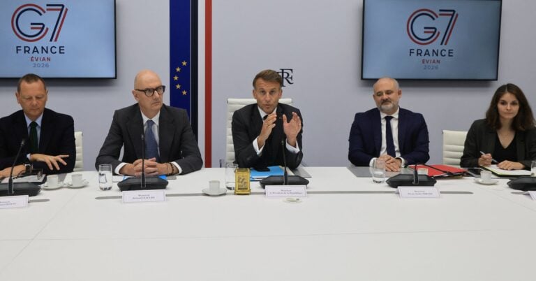 French President Emmanuel Macron (C) speaks next to French Presidential advisor Emmanuel Bonne (L), France