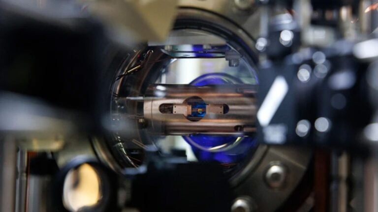 A close up of a laser table with lasers and mirrors on it