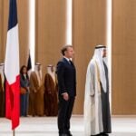 President Sheikh Mohamed and his French counterpart Emmanuel Macron stand for the national anthem at an official reception