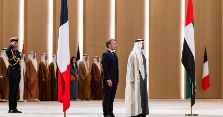 President Sheikh Mohamed and his French counterpart Emmanuel Macron stand for the national anthem at an official reception