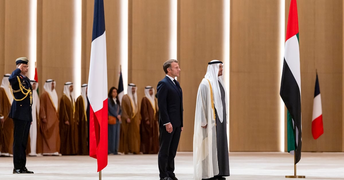 President Sheikh Mohamed and his French counterpart Emmanuel Macron stand for the national anthem at an official reception