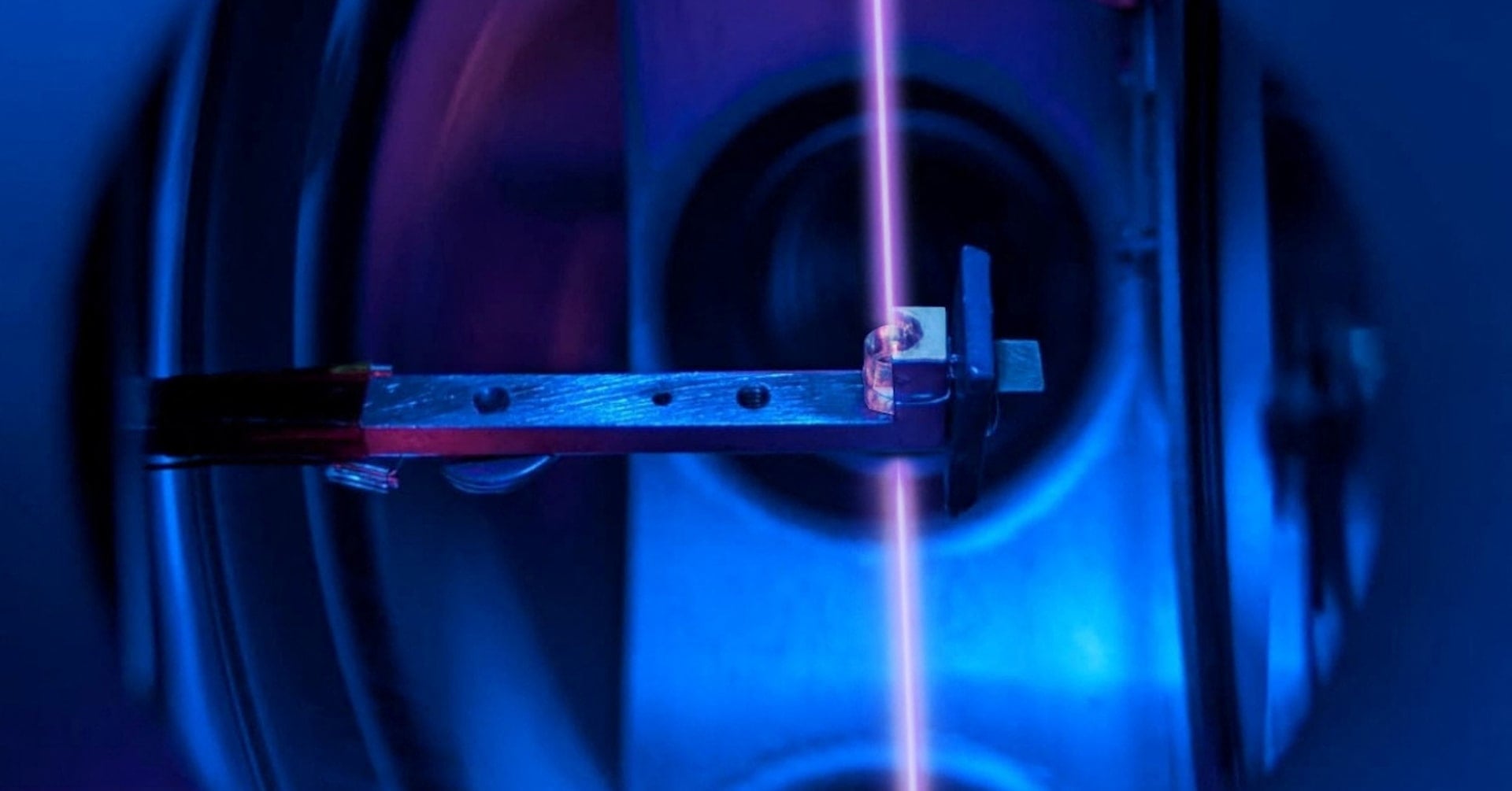 A calcium fluoride crystal, in its holder, that incorporates large numbers of thorium nuclei is seen inside the vacuum