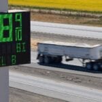 A semi drives past a sign advertising the price of diesel along Interstate 5 in Williams, California, U.S., September 28