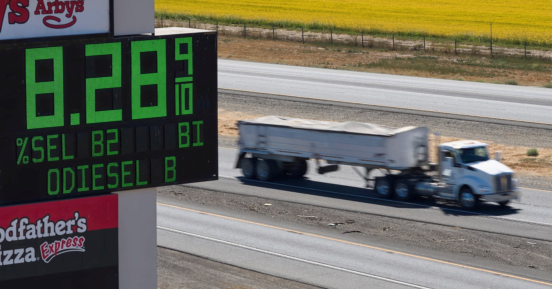 A semi drives past a sign advertising the price of diesel along Interstate 5 in Williams, California, U.S., September 28