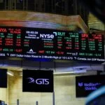 A screen displays stock market information after the opening bell at the New York Stock Exchange (NYSE) in New York City