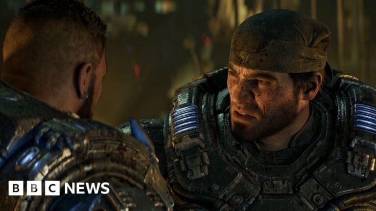 Gears of War character Marcus Fenix wears a bandanna and heavy futuristic armour. The CGI character has a cropped beard and