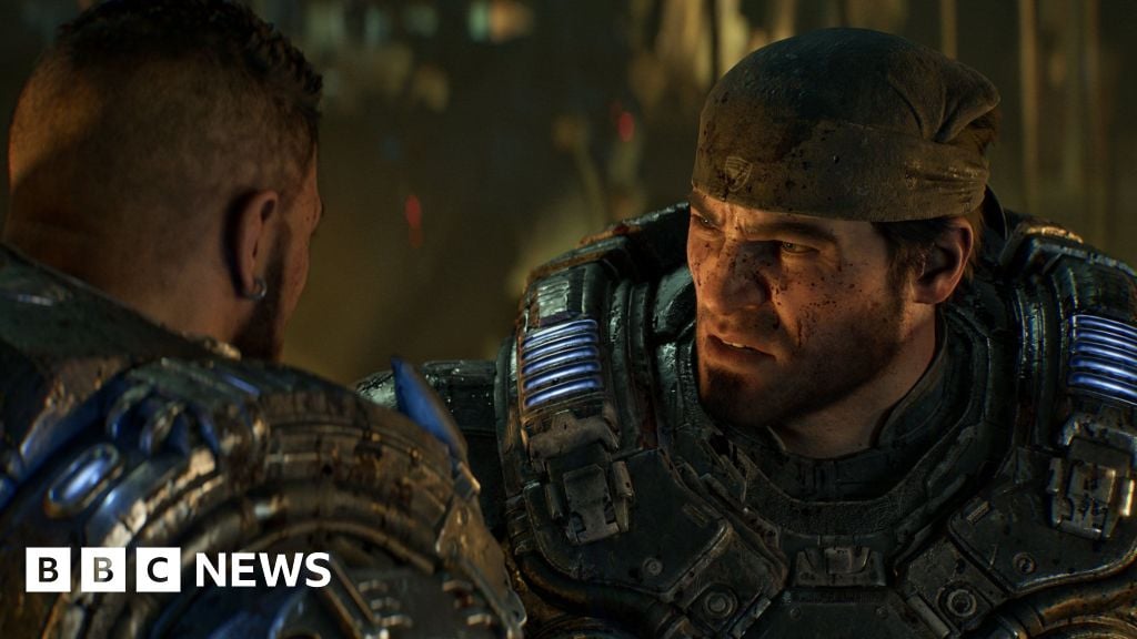 Gears of War character Marcus Fenix wears a bandanna and heavy futuristic armour. The CGI character has a cropped beard and