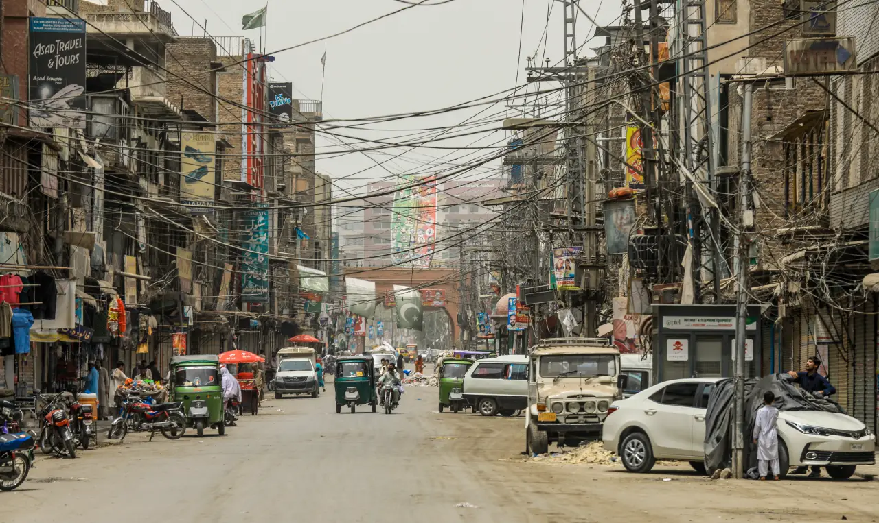Street traffic with cars and rickshaws in Peshawar, Pakistan